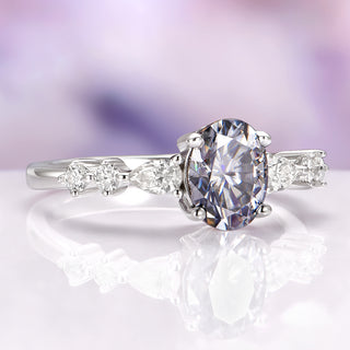 Diamond ring with a large central gemstone and smaller stones on a soft focus background