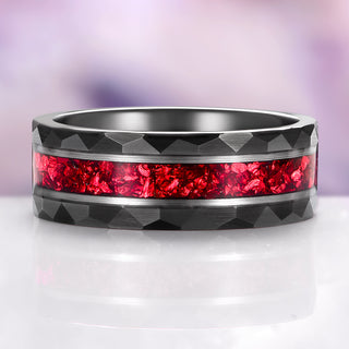 Ring with black and red design on a white surface with purple background