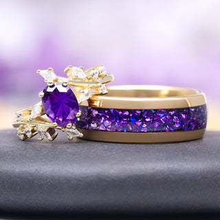 Gold ring with purple gemstone on a gray surface with a blurred purple background