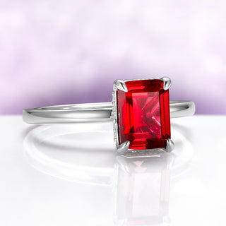 Raspberry Tourmaline Solitaire Engagement Ring in Sterling Silver by Aquamarise, featuring a radiant emerald-cut red gemstone on a sleek, polished silver band for a modern elegant look.