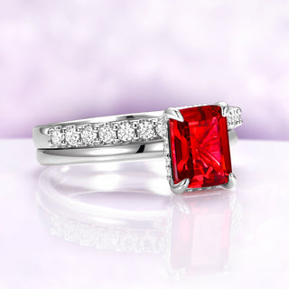 Raspberry Tourmaline Solitaire Engagement Ring in Sterling Silver by Aquamarise, featuring a radiant emerald-cut red gemstone with sparkling white accents on a polished silver band.