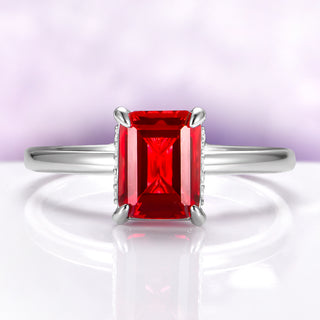 Raspberry Tourmaline Solitaire Engagement Ring in Sterling Silver by Aquamarise, featuring a vibrant emerald-cut red gemstone with a minimalist polished band design.