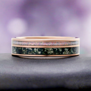 Moss Agate & Fire Opal Men's Ring in Rose Gold Tungsten by Aquamarise, resting on a grey stone pedestal.