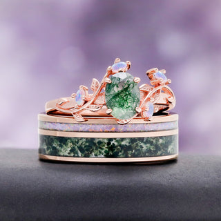 Rose Gold Vine Leaf Moss Agate & Fire Opal Couples Ring Set by Aquamarise, the vine leaf ring resting on its matching inlay band.