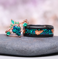 Skye Kite® Peacock Fire Opal & Emerald Engagement Ring Set in 14K Solid Rose Gold by Aquamarise Gold features vibrant green and blue gemstones with rose gold and black band accents.