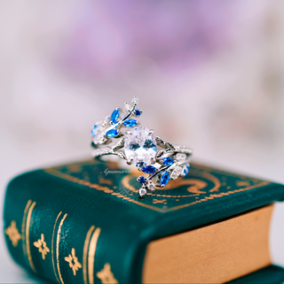 Oval Cut Moissanite & Blue Sapphire Leaf Engagement Ring Set in 14K White Gold