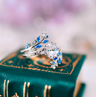Oval Cut Moissanite & Blue Sapphire Leaf Engagement Ring Set in 14K White Gold