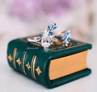 Oval Cut Moissanite & Blue Sapphire Leaf Engagement Ring Set in 14K White Gold