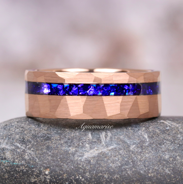 Midnight Blue Sapphire Wedding Band in Rose Gold Tungsten Carbide (8mm) featuring a hammered rose gold finish with a vibrant blue sapphire inlay by Aquamarise.