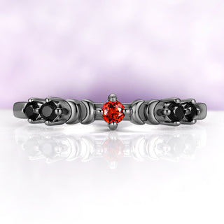 Selene Lab-Grown Padparadscha Sapphire & Onyx Moon Band in Black Ruthenium by Aquamarise, a round pink-orange sapphire between two crescent moons with black onyx clusters