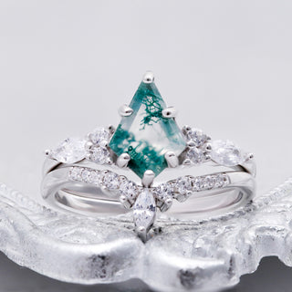 Skye Kite Green Moss Agate Ring by Aquamarise, displayed on a white textured surface to show the kite moss agate and crown band.