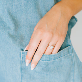 Hand with a diamond ring on a light blue background