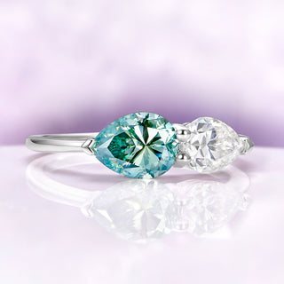Toi Et Moi Blue Moissanite Two Stone Engagement Ring in 14K White Gold by Aquamarise Gold, featuring pear-shaped blue and white moissanite stones in a sleek white gold band.