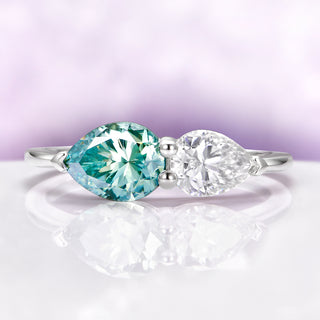 Toi Et Moi Blue Moissanite Two Stone Engagement Ring in 14K White Gold by Aquamarise Gold, featuring pear-shaped blue and white moissanite stones in a delicate white gold band.