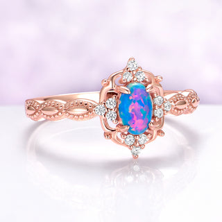 Rose gold ring with a colorful gemstone on a light purple background