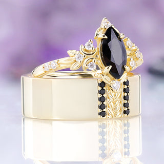 Angled view of the Viridian black onyx men's band with the matching women's ring resting on it, sold together as a couples set