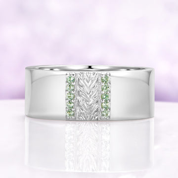 Mens 8mm sterling silver wedding band with a carved leaf panel and green tourmaline channels