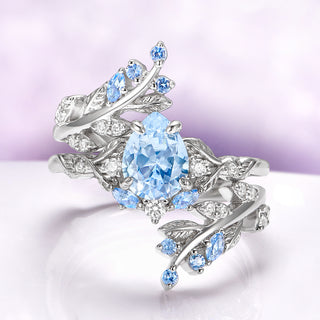 Wisteria Aquamarine Fairy Leaf Ring- 14K White Gold (Two Piece) by Aquamarise Gold, featuring aquamarine center and leaf-inspired white gold band with delicate blue gemstone accents.
