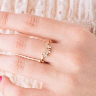 yellow gold ring with small diamonds on a hand