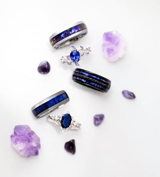 Collection of purple and blue gemstone rings on a white background