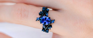 Blue gemstone ring on a finger