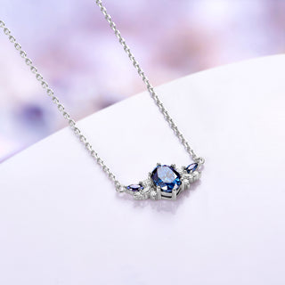 Blue moissanite cluster necklace shown at an angle with its 18 inch sterling silver cable chain