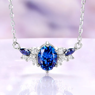 Oval midnight blue moissanite cluster necklace in sterling silver with blue marquise and clear moissanite accents
