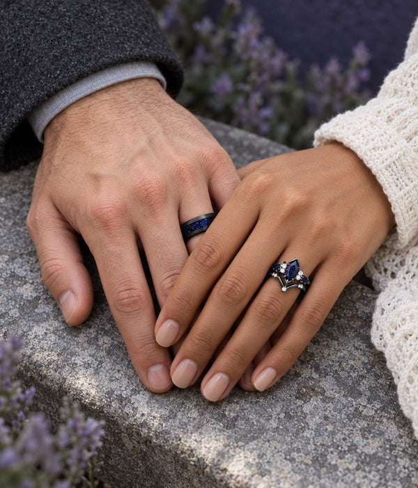 Couple's hands on a stone ledge beside lavender, his black band with blue sandstone inlay and her kite-cut blue sandstone engagement ring, Aquamarise banner