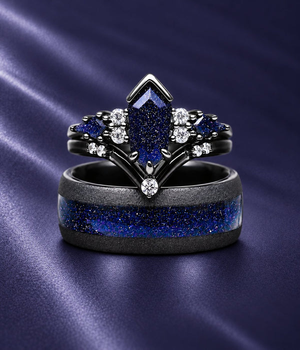 Couples ring set on navy satin: black kite-cut blue sandstone engagement ring with chevron band and white accents stacked on a black men's band with blue sandstone inlay, Aquamarise banner