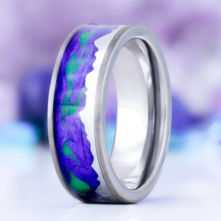 Borealis mountain range men's wedding band in tungsten, 8mm, standing view showing the purple and green aurora inlay above the silver mountain skyline