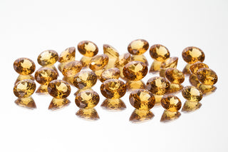 Collection of yellow gemstones on a white background
