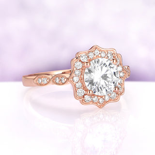 Angled view of the Cordelia ring in 14K rose gold, showing the vintage scalloped halo and the diamond-set marquise stations along the shank