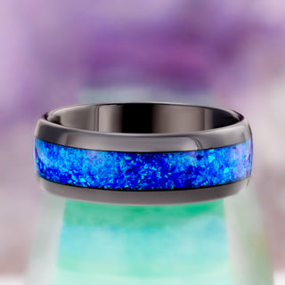 Front view of the polished black tungsten men's band with a wide crushed blue opal inlay