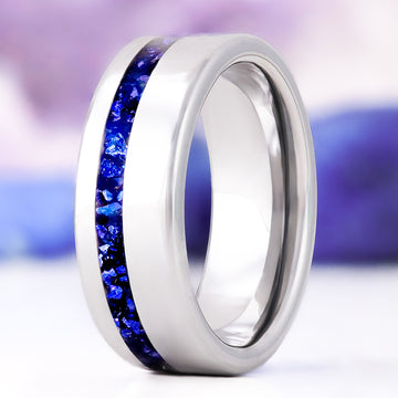 Crushed Blue Sapphire men's wedding band in polished silver tungsten carbide, 8mm, standing upright with an off-set channel of deep blue crushed sapphire