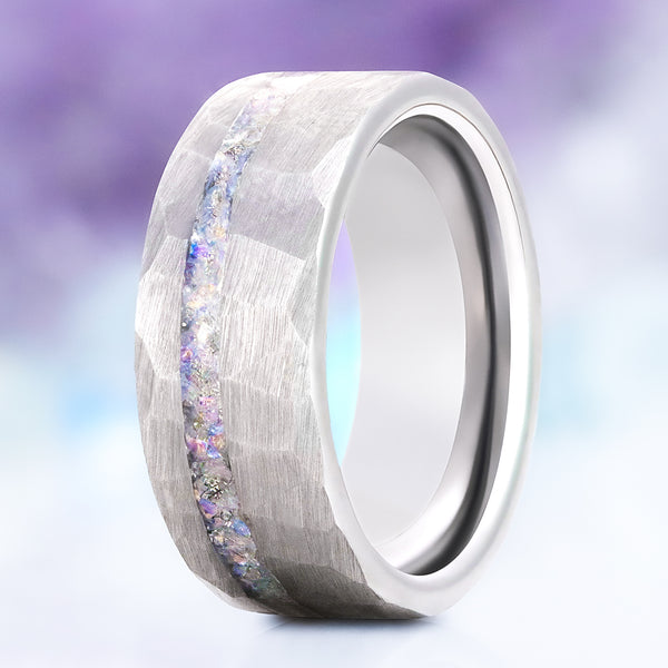Crushed moonstone men's wedding band in hammered silver tungsten carbide, 8mm, standing view showing the iridescent moonstone channel and faceted finish