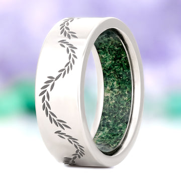 Crushed moss agate leaf men's wedding band in polished titanium, 8mm, standing view showing the engraved laurel vine and the moss agate inner sleeve