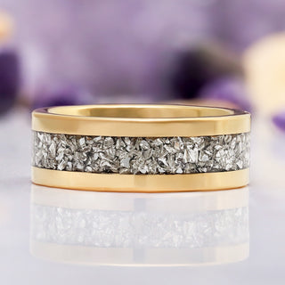 Gold tungsten wedding band with crushed simulated diamond inlay photographed at an angle