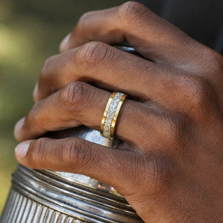 Man wearing the 8mm Crushed Simulated Diamond men's wedding band in gold tungsten, sparkling crushed stone inlay channel between polished gold rails