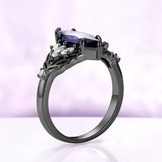 Side profile of the Eilwen blue sapphire leaf ring, showing how low the elongated marquise sits in its six prongs above the black ruthenium band