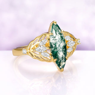 Angled view of the Eilwen moss agate ring in yellow gold vermeil, showing the marquise leaves on each shoulder and the small round stones on the split shank