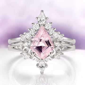 Ring with pink gemstone and diamond accents on a light purple background