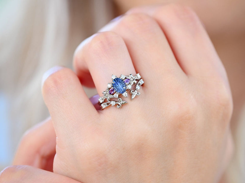Faelight Cut blue sapphire oval leaf ring set with amethyst accents in sterling silver, worn on a hand
