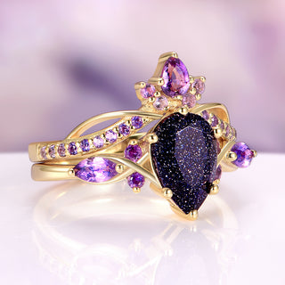 Gold ring with purple gemstones on a white background