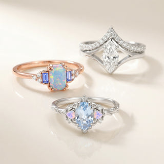 Three elegant rings with gemstones on a light background