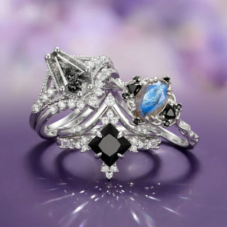 Three silver rings with gemstones on a purple background