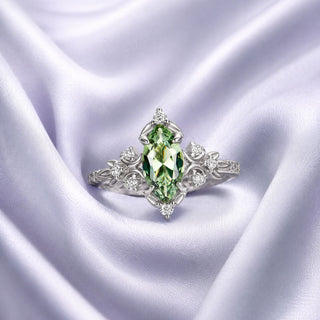 Sterling silver marquise green gemstone ring with a vintage leaf setting on lilac satin, Aquamarise vertical collection banner