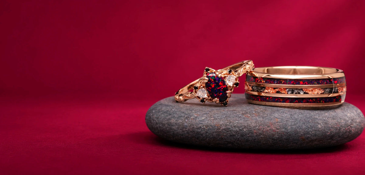 Esme Black Fire Opal & Meteorite couples ring set in rose gold on a grey stone against a burgundy backdrop, Aquamarise Halloween 2026