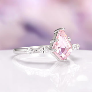 Pink gemstone ring with silver setting on a soft, blurred background