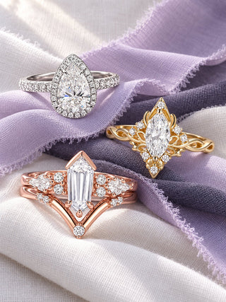 Lab-grown diamond engagement rings on lavender silk: Elodie pear halo in white gold, marquise butterfly ring in yellow gold and elongated hexagon ring set in rose gold, Aquamarise banner