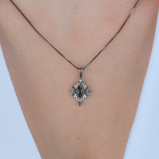 Model wearing the Nightbriar lab-grown alexandrite pendant necklace in black ruthenium